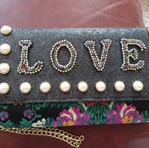 Aldo clutch decorated with pearls and embroidery.